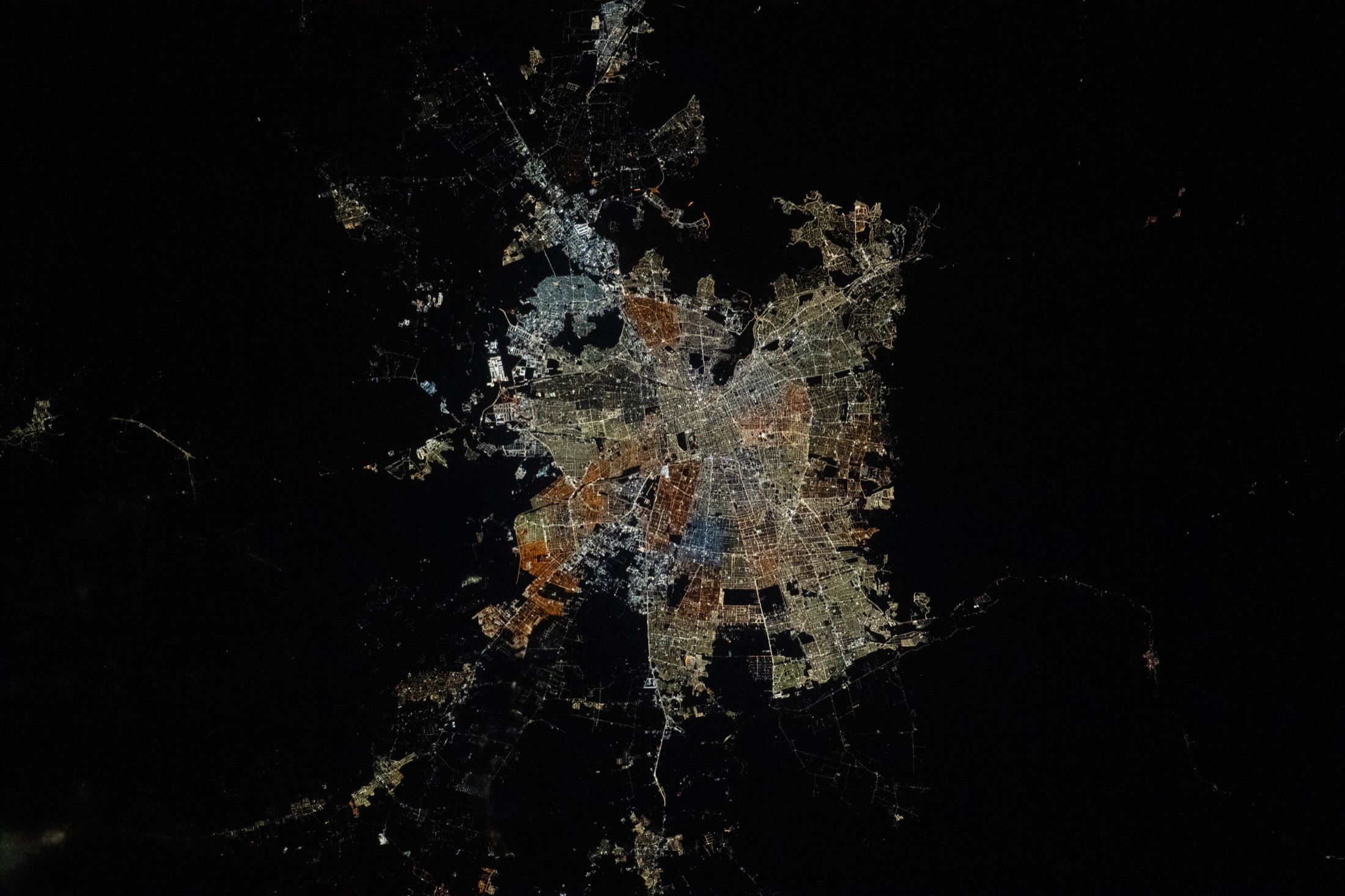 Chile (Santiago area) at night photographed from orbit, with city lights visible.
